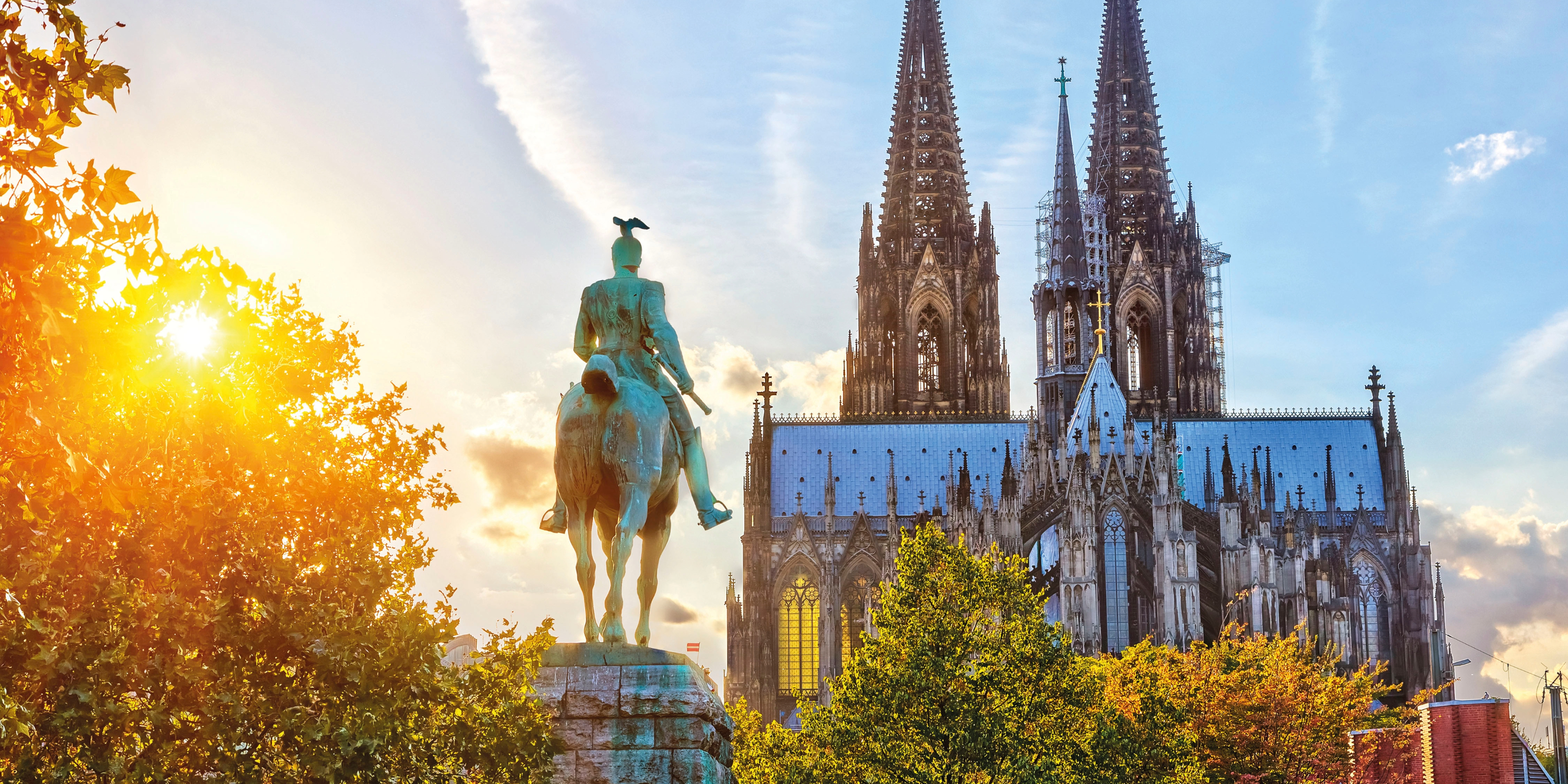 Cologne Cathedral with monument at sunset