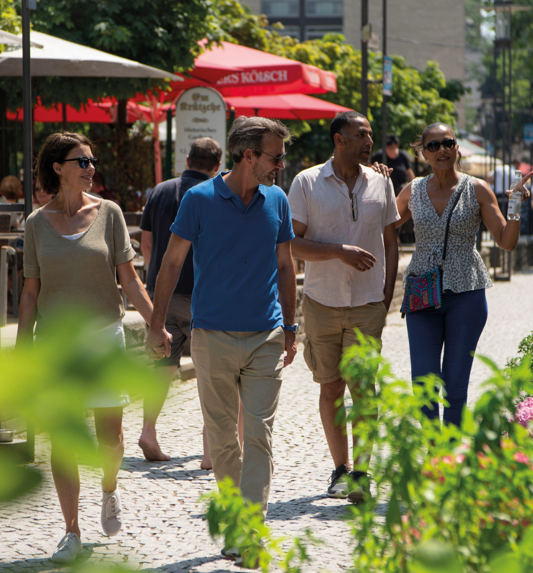 People walking down cobbled European street