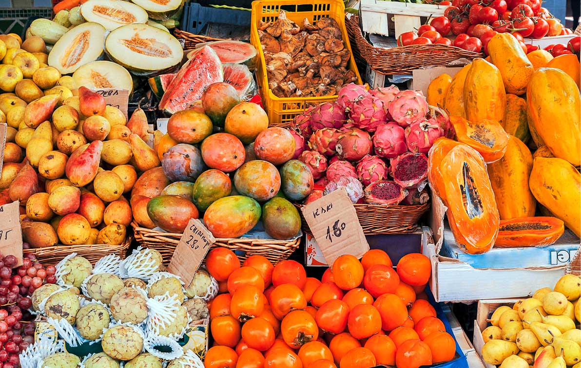 A fruit stall with watermelons, pears, mangos and more