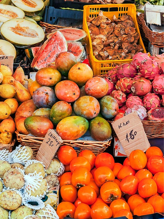 A fruit stall with watermelons, pears, mangos and more