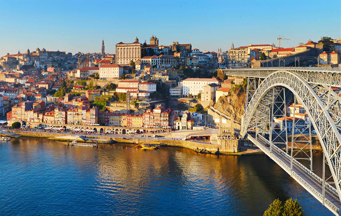 A view over Porto across the Douro River at sunrise