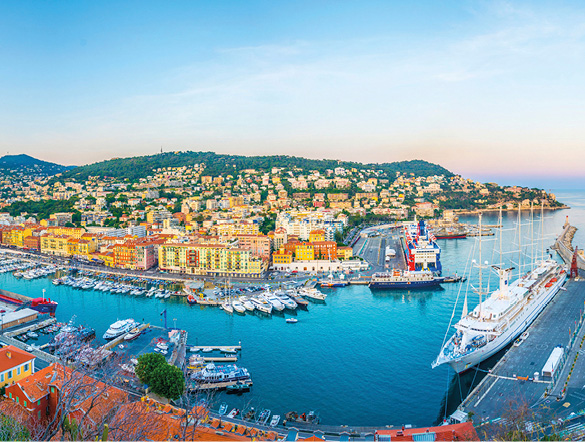 Port Lympia in Nice filled with boards in the water with the sun shining