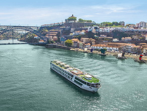 Luxury cruise ship sailing the Douro River past the buildings of Porto