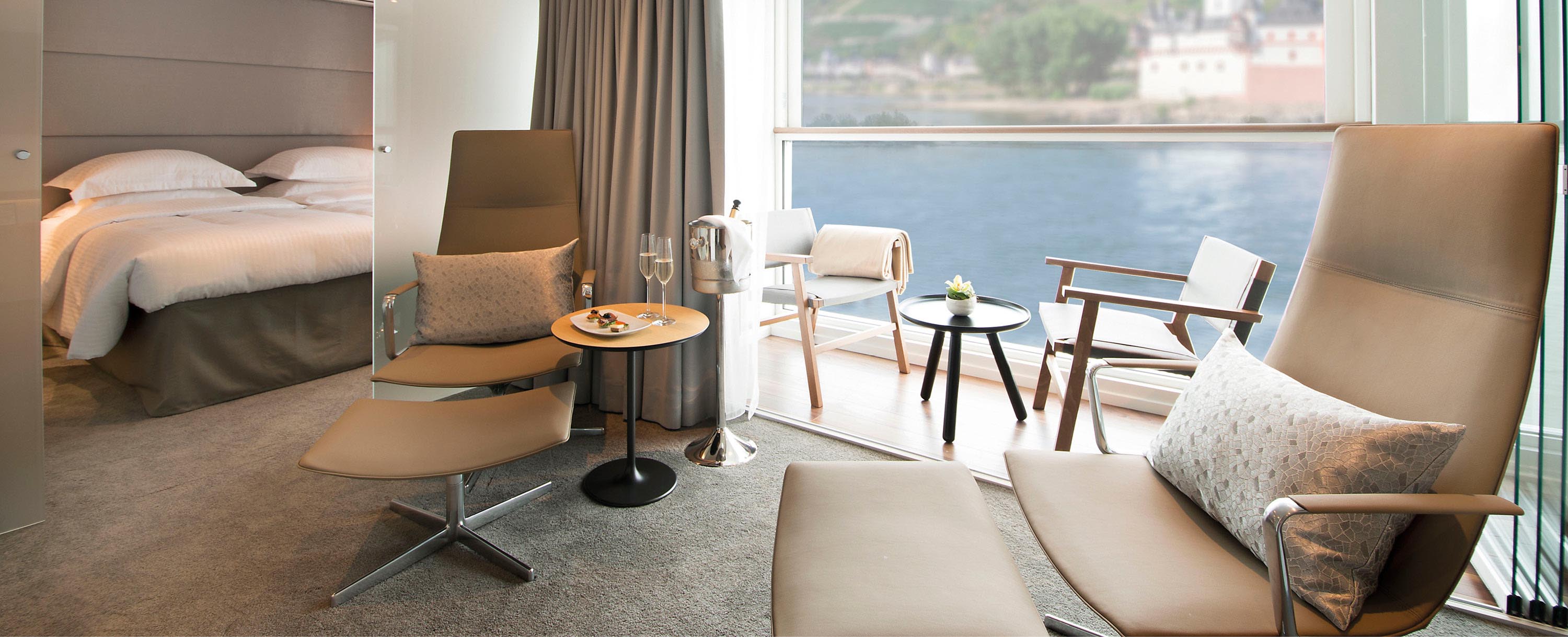 European town views from the balcony and seating area of the Owner’s One-Bedroom Suite on board Emerald Cruises’ Star-Ships