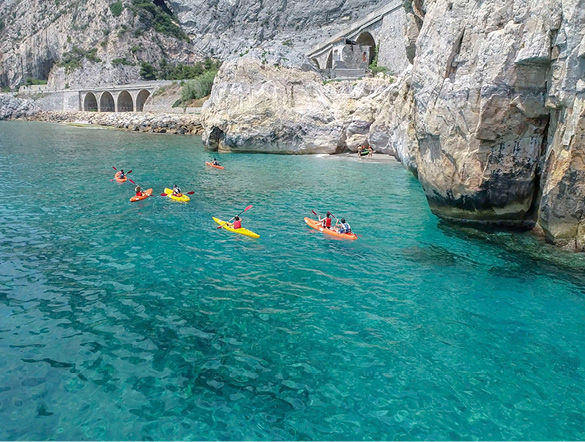 A group kayaking along the Amalfi Coast